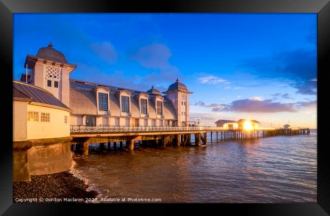 Winter sunrise reflecting off Penarth Pier Framed Print by Gordon Maclaren