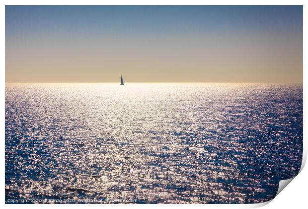 A backlit sailboat at sea Print by Jordi Carrio