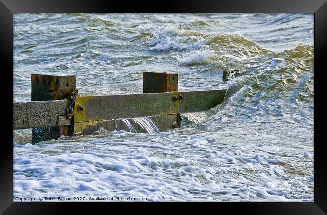 Waves break over a wooden groyne at Southend on Sea, Essex, UK Framed Print by Peter Bolton