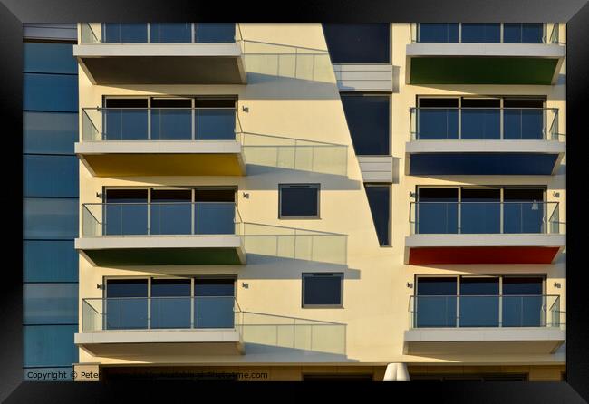 Apartments at Westcliff on Sea form abstract patterns in the sunlight . Framed Print by Peter Bolton