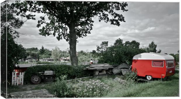 Red trailer parked next to a big tree Canvas Print by Sandra Broenimann