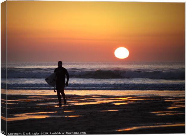 Surfer at Sunset Canvas Print by Nik Taylor
