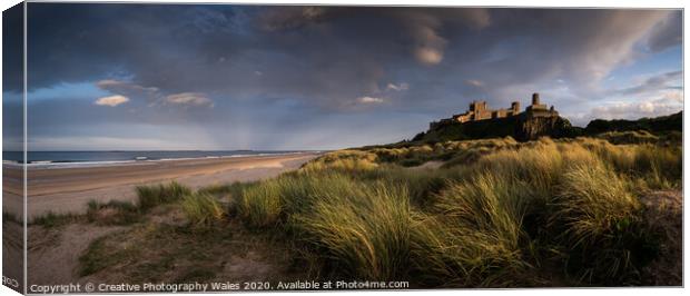 Bamburgh Castle on the Northumberland Coast Canvas Print by Creative Photography Wales