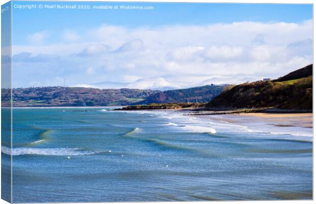 Benllech Beach Anglesey and Snowy Mountains Canvas Print by Pearl Bucknall