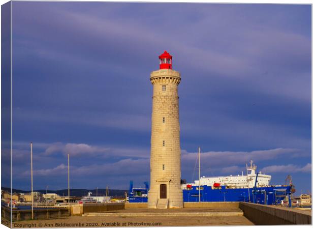 Sete Lighthouse under stormy skys Canvas Print by Ann Biddlecombe