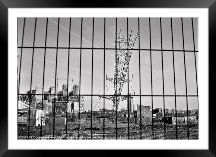 Upside down electricity pylon. Greenwich, London  Framed Mounted Print by Kevin Plunkett