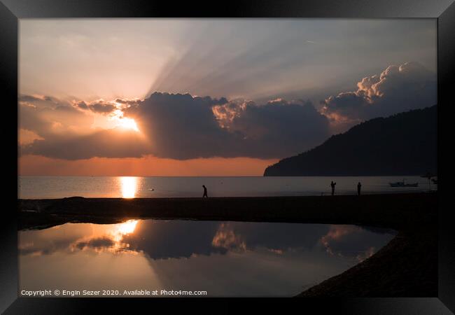 Wonderful sunrise, sunbeams and tourists at The Be Framed Print by Engin Sezer