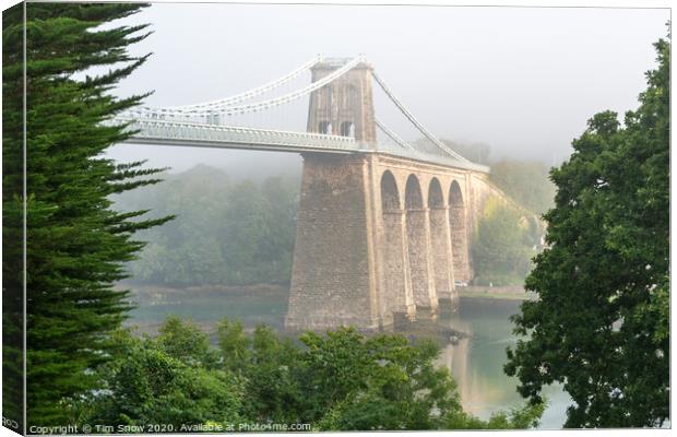 Foggy Menai Suspension bridge crossing over to Anglesey Canvas Print by Tim Snow