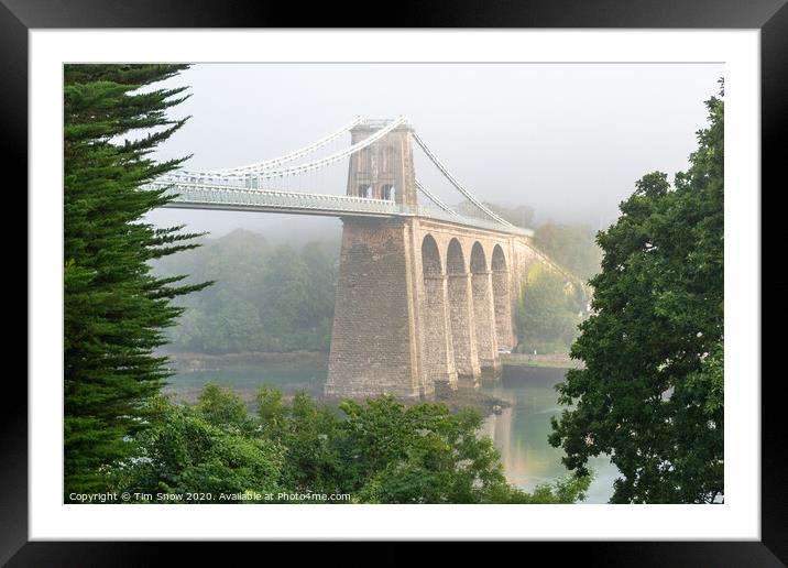 Foggy Menai Suspension bridge crossing over to Anglesey Framed Mounted Print by Tim Snow