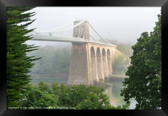 Foggy Menai Suspension bridge crossing over to Anglesey Framed Print by Tim Snow