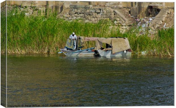 Local fishermen moored on the Nile riverbank near Cairo, Egypt. Canvas Print by Peter Bolton