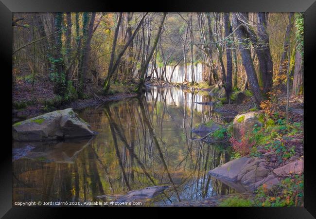 Reflections in the river in the middle of autumn Framed Print by Jordi Carrio