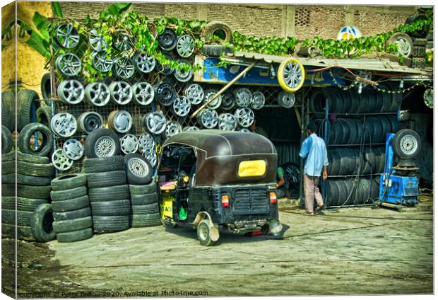 Tyre fitter business on the outskirts of Cairo, Egypt. Canvas Print by Peter Bolton