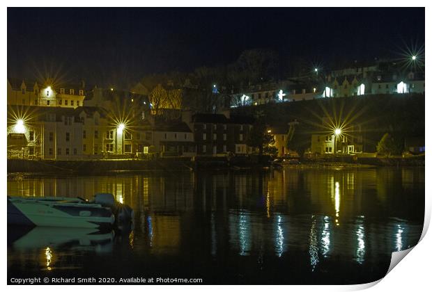 Illuminated buildings at the beach end of Portree Harbour Print by Richard Smith