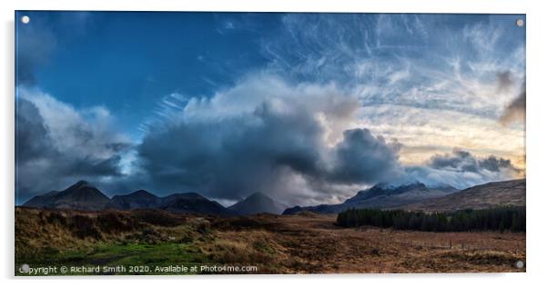 The sun setting to the right of a panorama of the red and black Cuillin Hills. Acrylic by Richard Smith
