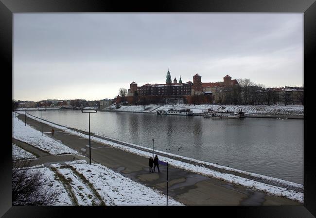 Krakow, Poland - January 29, 2015: Wide angle view of famous wawel castle covered with snow next to vistual river against cloudy sky Framed Print by Arpan Bhatia