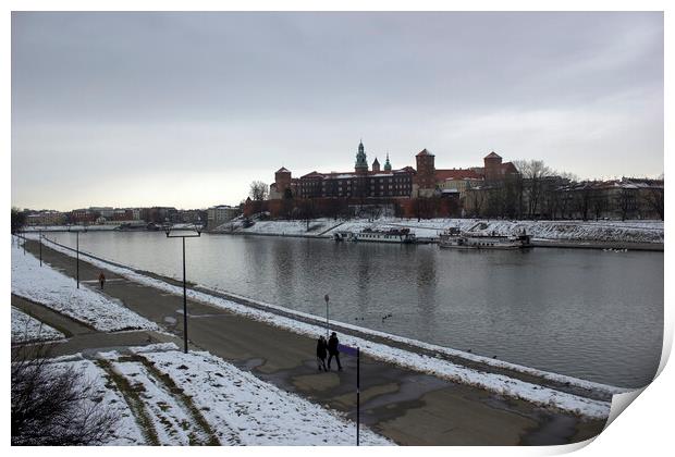 Krakow, Poland - January 29, 2015: Wide angle view of famous wawel castle covered with snow next to vistual river against cloudy sky Print by Arpan Bhatia