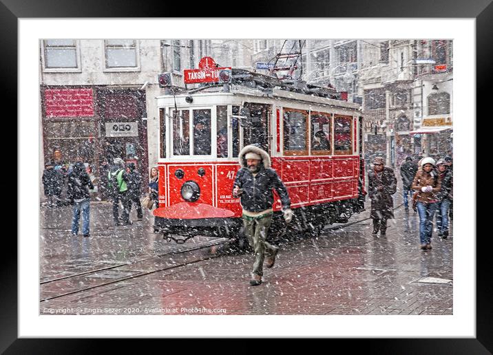 A nostalgic tram was passing by The Istiklal Street when snowfalls at Istanbul Framed Mounted Print by Engin Sezer