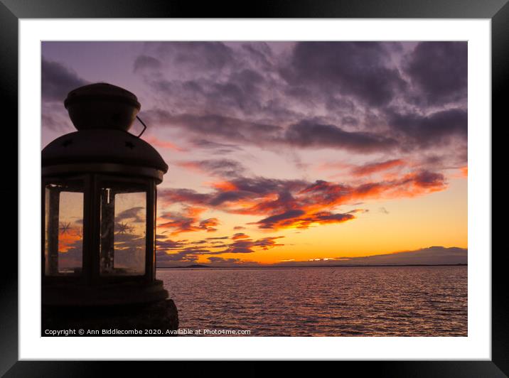 Lantern in the sunset over the lagoon Framed Mounted Print by Ann Biddlecombe