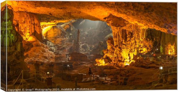 The illuminated limestone Sung Sot caves in the UNESCO World Heritage Site of Ha Long Bay in Northern Vietnam. Canvas Print by SnapT Photography