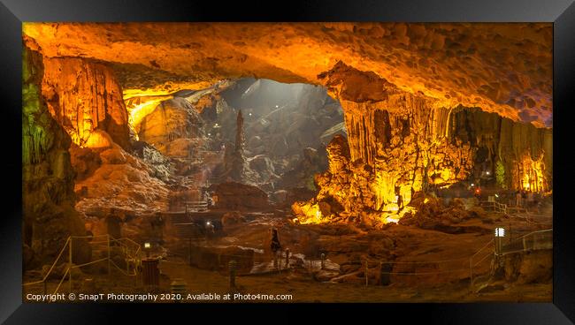 The illuminated limestone Sung Sot caves in the UNESCO World Heritage Site of Ha Long Bay in Northern Vietnam. Framed Print by SnapT Photography