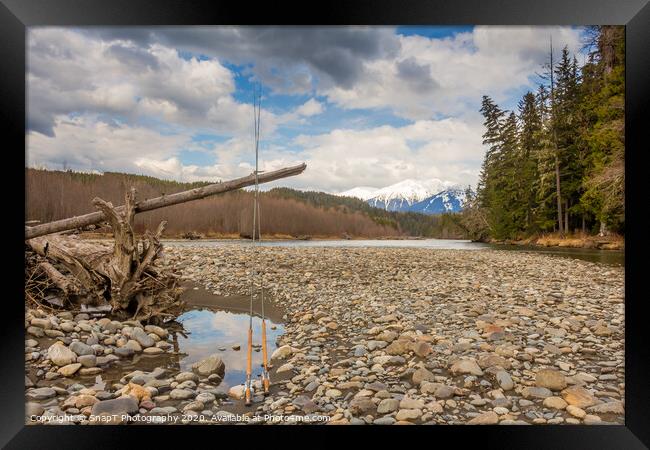 Two fly fishing rods on a dead tree on a river in British Columbia Framed Print by SnapT Photography