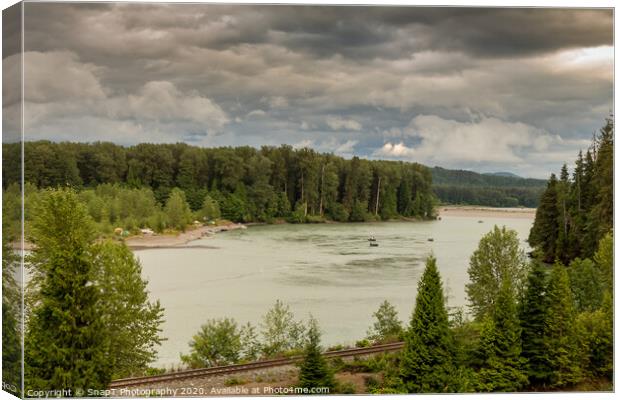 Fishermen fishing for salmon on the Skeena River below Terrace, during a cloudy day in summer, beside the CN Railway Line. Canvas Print by SnapT Photography