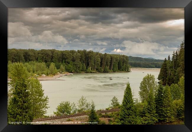 Fishermen fishing for salmon on the Skeena River below Terrace, during a cloudy day in summer, beside the CN Railway Line. Framed Print by SnapT Photography