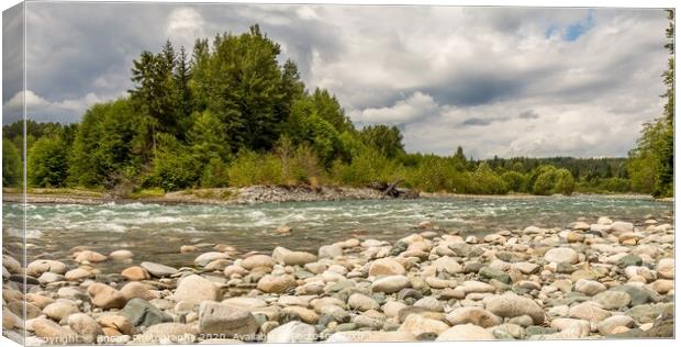 A boulder strewn, fast flowing river, beside a forest, on a cloudy day. Canvas Print by SnapT Photography