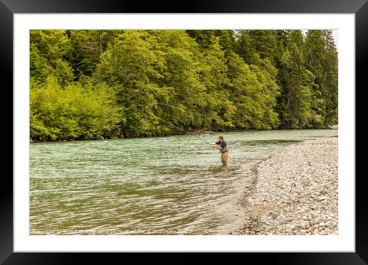 A fly fisherman spey casting, while wading in the fast flowing Kitimat River Framed Mounted Print by SnapT Photography