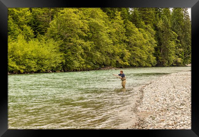 A fly fisherman spey casting, while wading in the fast flowing Kitimat River Framed Print by SnapT Photography