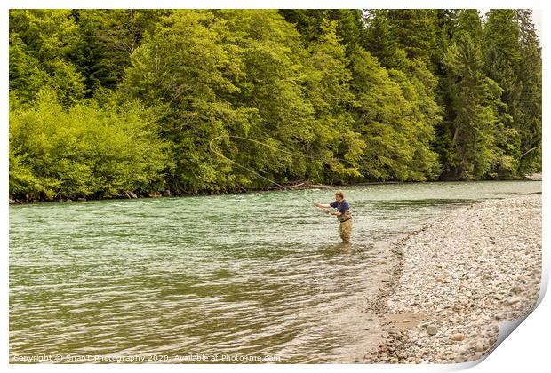 A fly fisherman spey casting, while wading in the fast flowing Kitimat River Print by SnapT Photography