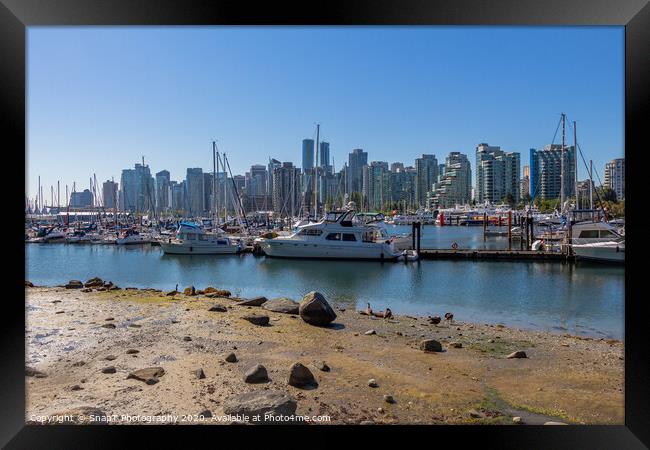 The Vancouver skyline across Coal Harbour from the sea wall on Stanley Park Framed Print by SnapT Photography