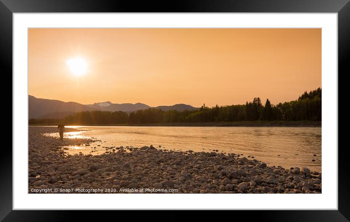 A fisherman walking along a gravel bar beside the Skeena River at sunset Framed Mounted Print by SnapT Photography