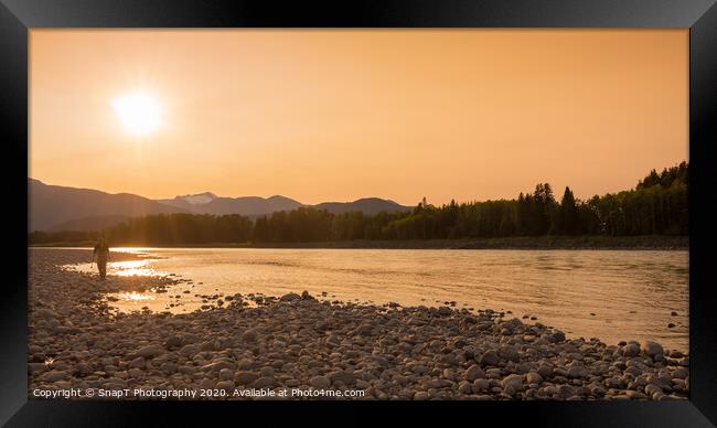 A fisherman walking along a gravel bar beside the Skeena River at sunset Framed Print by SnapT Photography