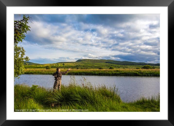 A fisherman fly fishing in the evening on the Blac Framed Mounted Print by SnapT Photography