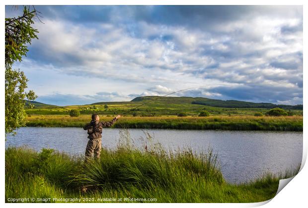 A fisherman fly fishing in the evening on the Blac Print by SnapT Photography
