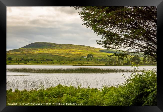 A view of Loch Stroan with a reed bed and the hill Framed Print by SnapT Photography