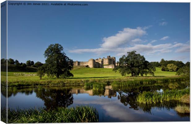 Alnwick Castle reflected in the River Aln. Canvas Print by Jim Jones