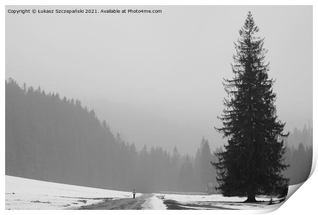 Lonely man walking by big tree Print by Łukasz Szczepański