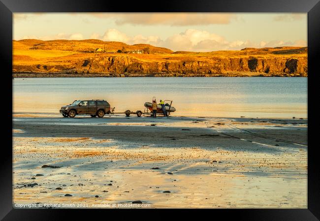 Launching a boat from Bharcasaig Beach. Framed Print by Richard Smith
