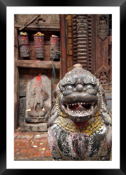 Fu Sculpture with Buddhist Prayer Wheels in Backgr Framed Mounted Print by Serena Bowles