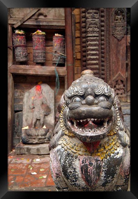 Fu Sculpture with Buddhist Prayer Wheels in Backgr Framed Print by Serena Bowles