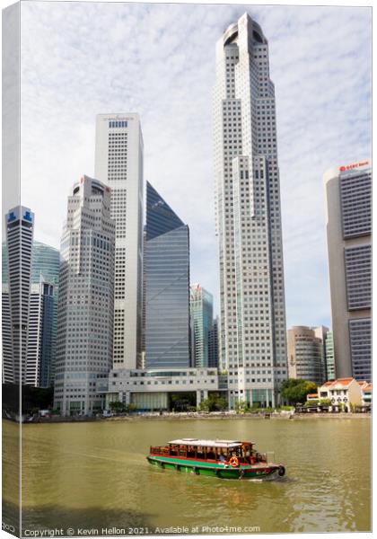 Bumboat on the Singapore river with the tall buildings of the fi Canvas Print by Kevin Hellon