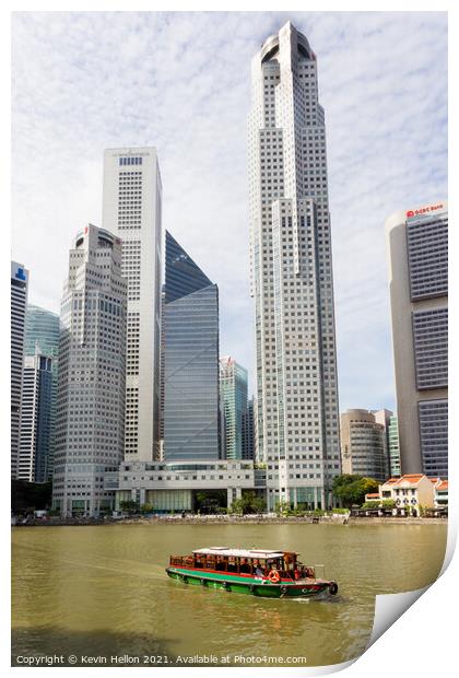 Bumboat on the Singapore river with the tall buildings of the fi Print by Kevin Hellon