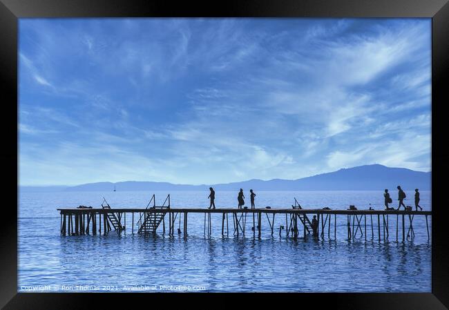 Silhouettes on a Wooden Pier in Corfu. Framed Print by Ron Thomas
