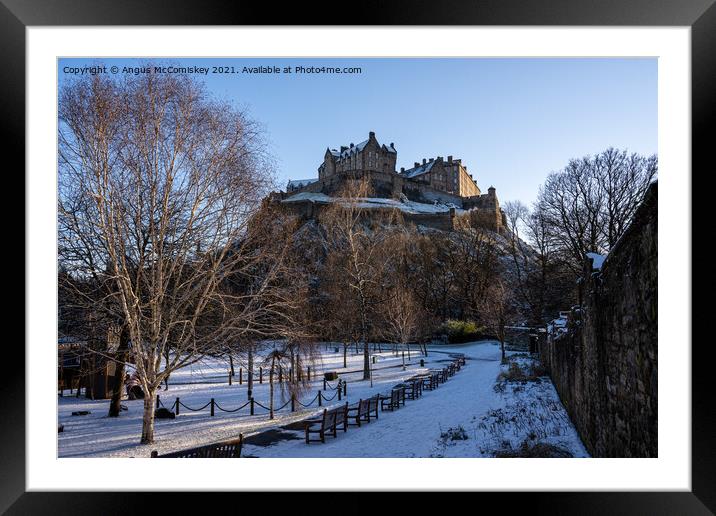 Edinburgh Castle snow from Princes Street Gardens Framed Mounted Print by Angus McComiskey