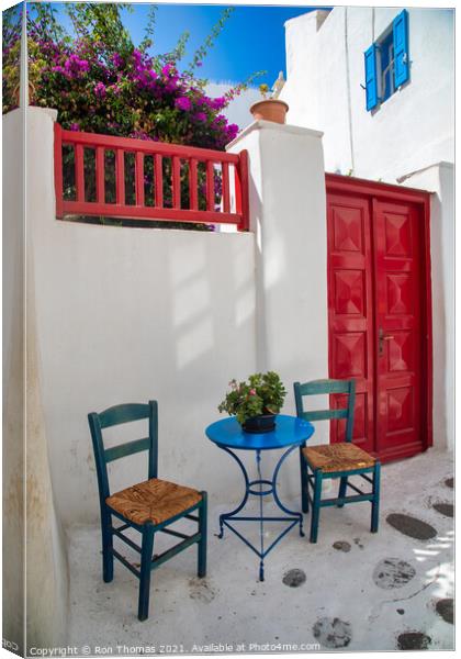A Table and Two Chairs, Mykonos Town. Canvas Print by Ron Thomas