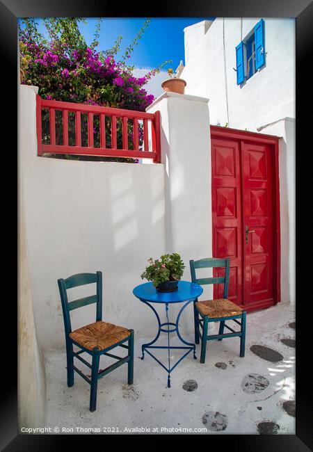 A Table and Two Chairs, Mykonos Town. Framed Print by Ron Thomas