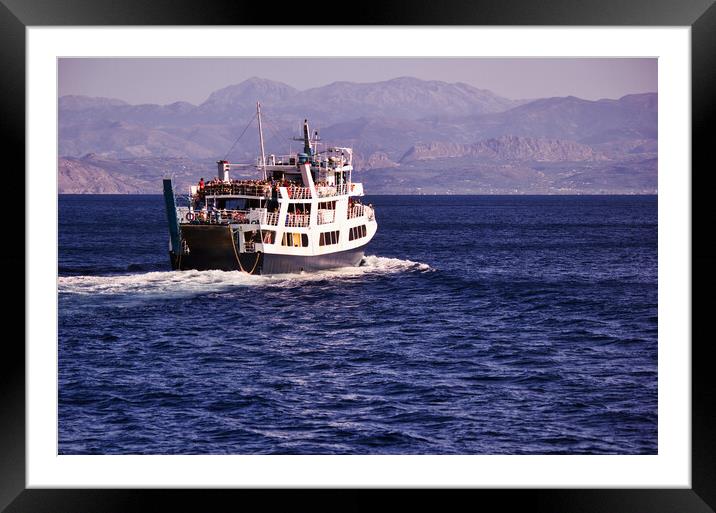 Crete or Kreta, Greece - September 15, 2017: Spirit of Athos ship which is a passenger vessel sailing away in the mediterranean sea against rocky terrain island during daytime Framed Mounted Print by Arpan Bhatia